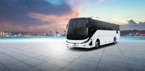 A modern bus parked in a scenic location in Ajman, showcasing the convenience and luxury of bus rental services in the city.