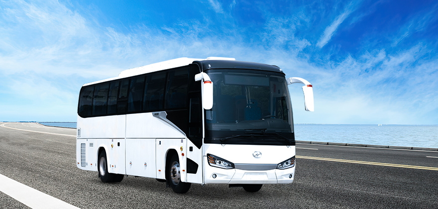 A modern bus parked in a scenic location in Ajman, highlighting the convenience and luxury of bus rental services in the city.