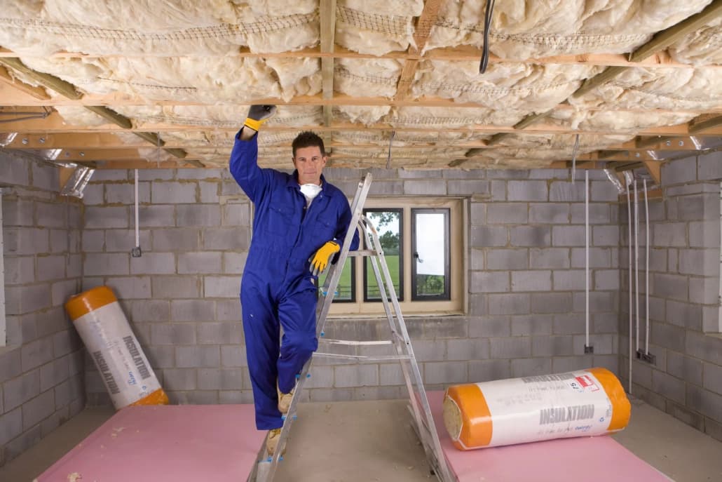 worker doing interior insulation