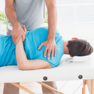 a chiropractor treats a patient's back