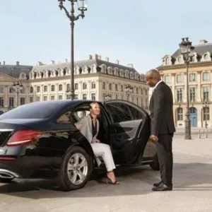 Private driver assisting passenger during airport transfer in Saudi Arabia