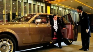 Premium chauffeur service vehicle parked outside a luxury hotel in Riyadh